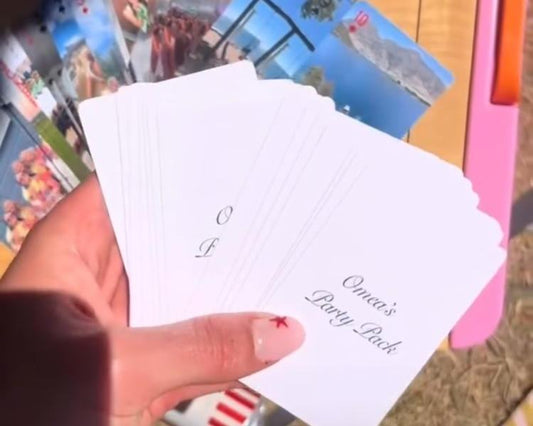 Hand holding Mimies card backs printed with a customer's own deck name