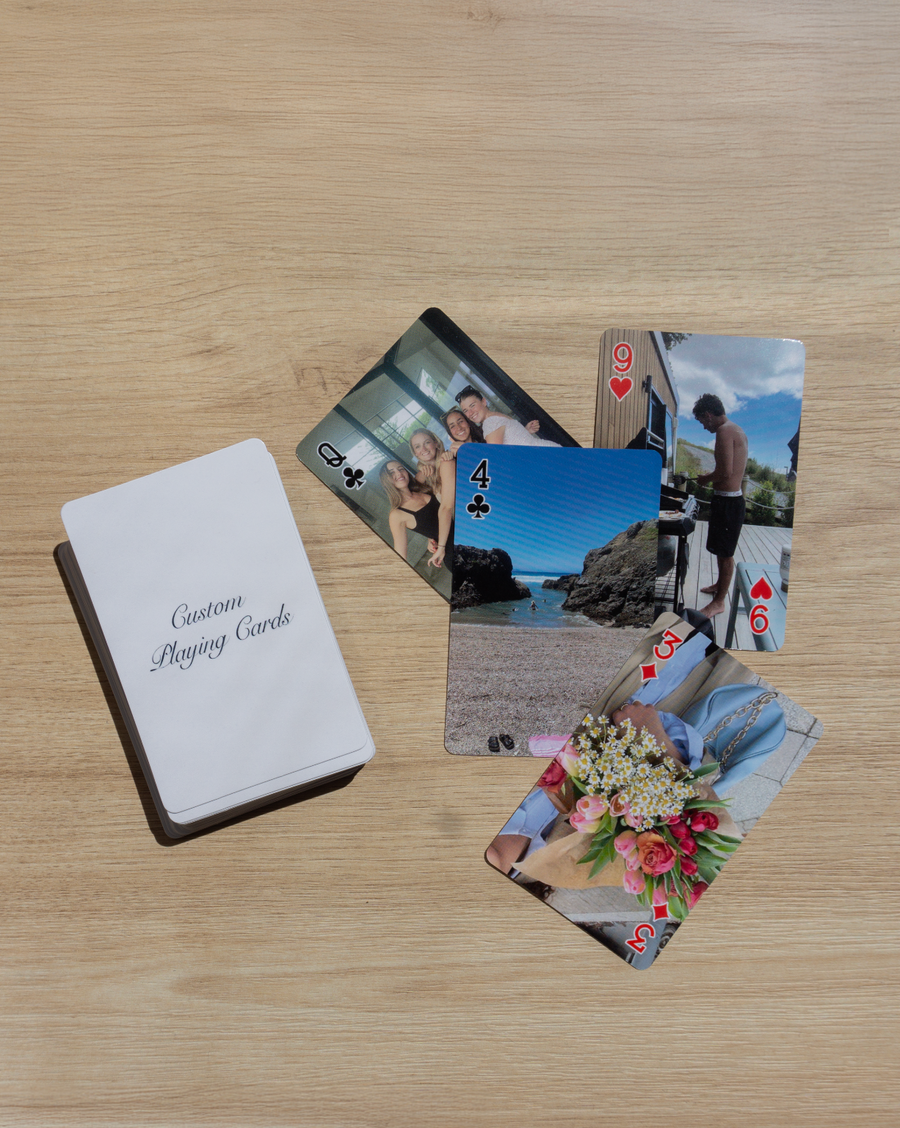 Personalised photo playing cards and their box on a wooden table