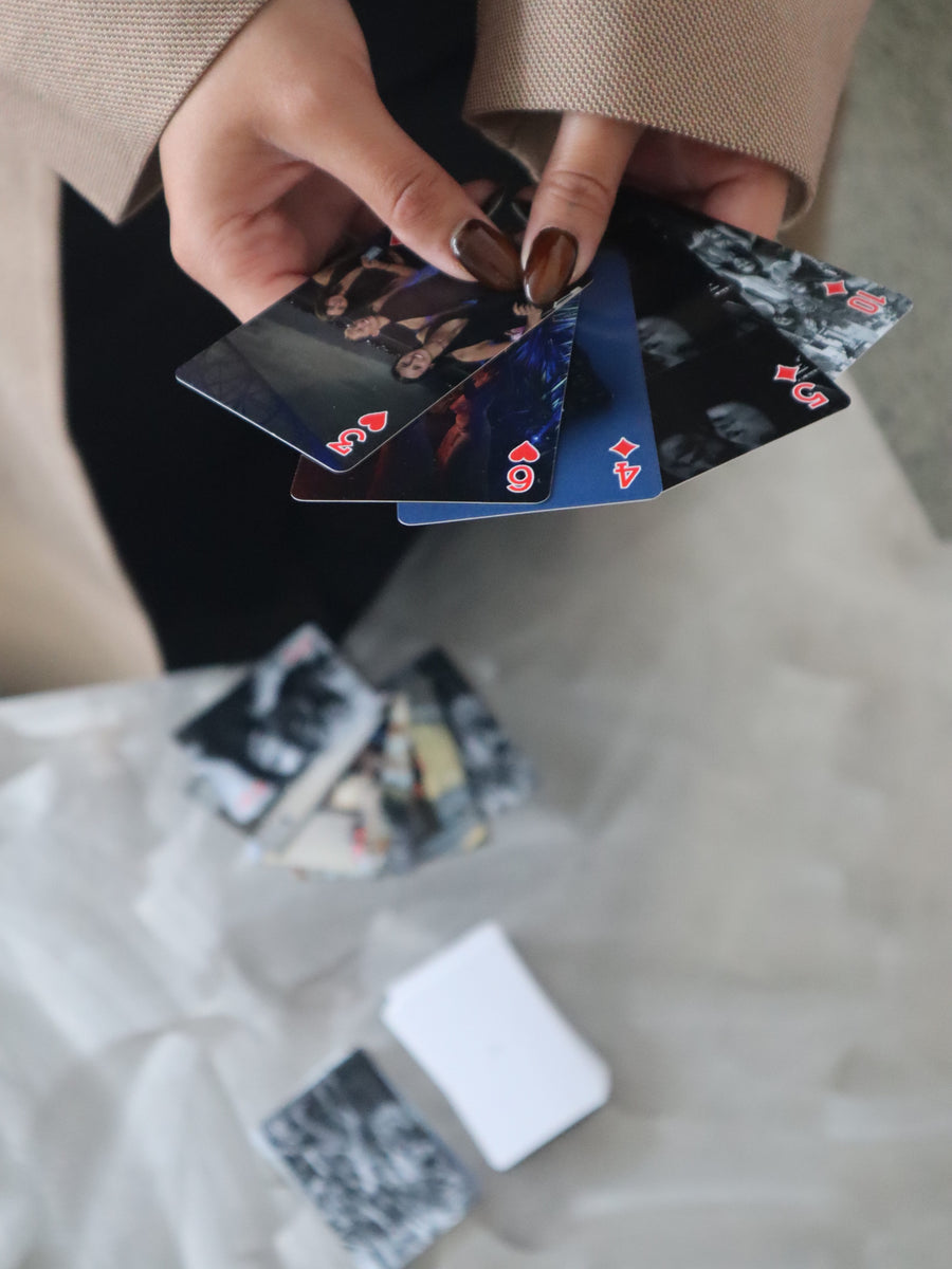 Hands holding personalised photo playing cards